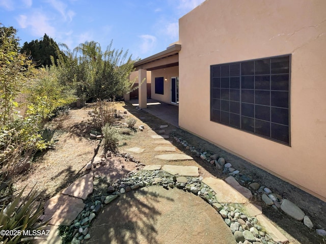 view of side of home with a patio