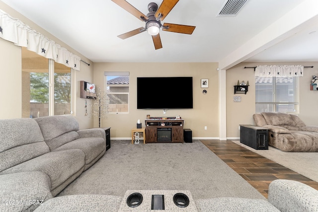 living room featuring dark wood-type flooring and ceiling fan