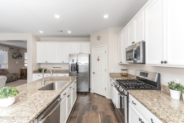 kitchen with appliances with stainless steel finishes, sink, and white cabinets