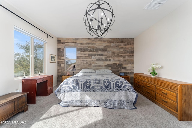 bedroom featuring a notable chandelier, carpet floors, and wooden walls