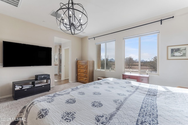 carpeted bedroom featuring a notable chandelier