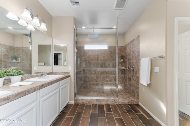 bathroom featuring vanity and a shower with door