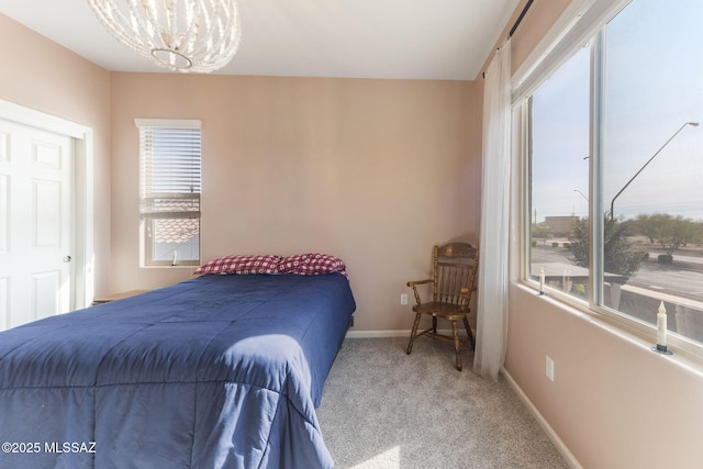 bedroom featuring an inviting chandelier and carpet