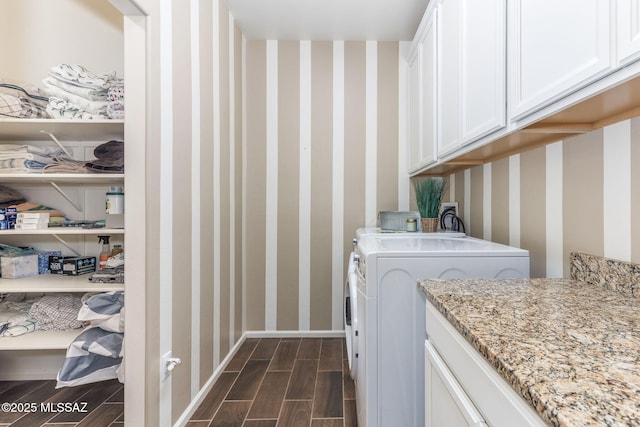 clothes washing area featuring cabinets and washer / dryer