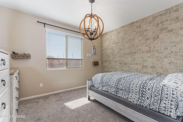 bedroom featuring brick wall, a chandelier, and carpet