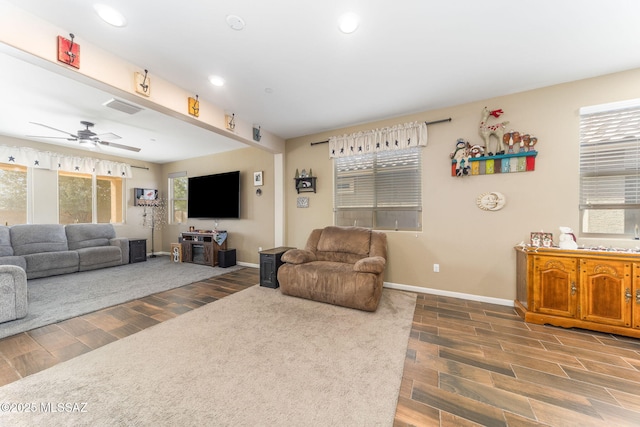 living room with a wealth of natural light and ceiling fan