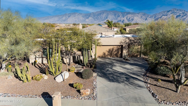 view of front facade featuring a mountain view and a garage