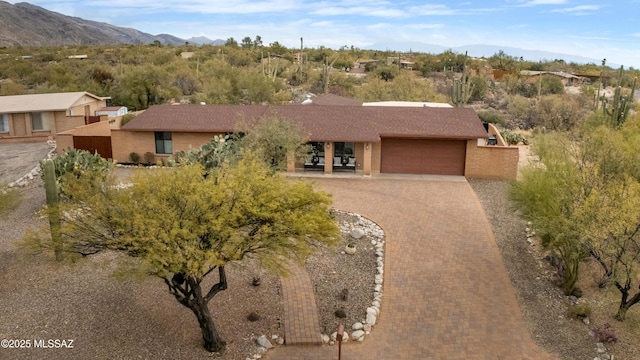 view of front facade featuring a garage and a mountain view