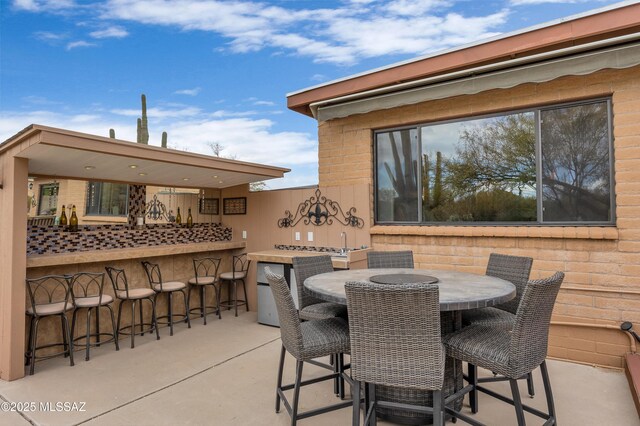 view of patio featuring a mountain view, a fenced in pool, an outdoor fireplace, and an outdoor fire pit