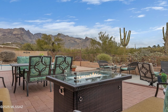 view of patio / terrace featuring a mountain view and a fire pit