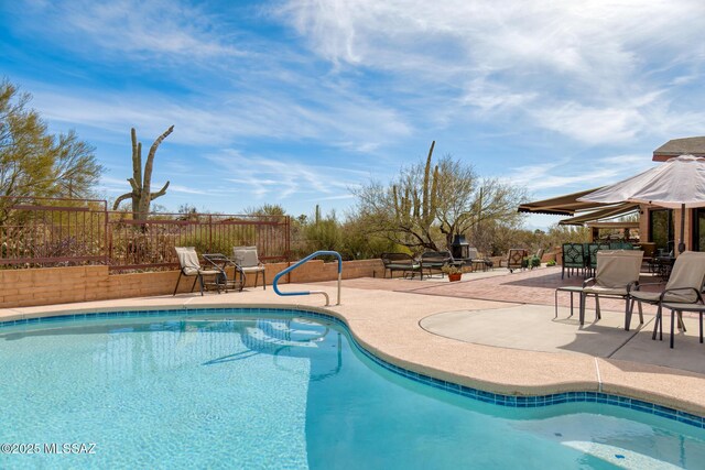 view of patio with a mountain view and exterior fireplace