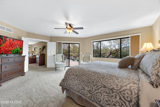 bedroom featuring ceiling fan, light colored carpet, and access to exterior