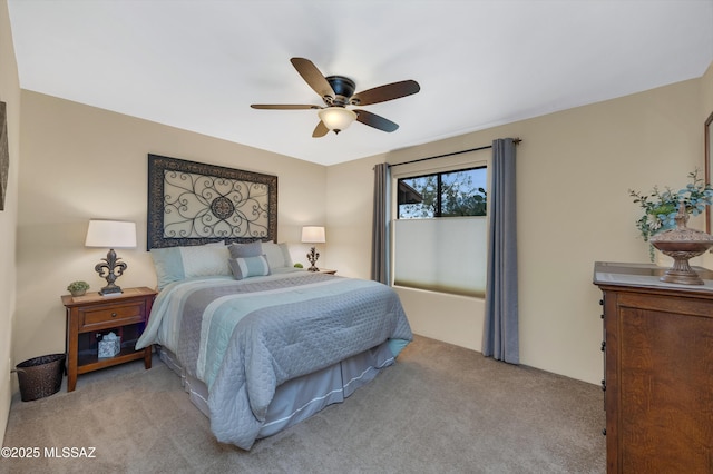 bedroom featuring light colored carpet and ceiling fan