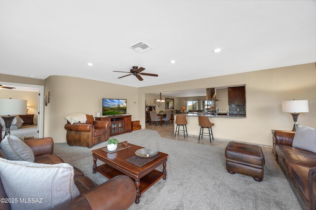 kitchen with dark brown cabinetry, extractor fan, tasteful backsplash, appliances with stainless steel finishes, and light stone countertops