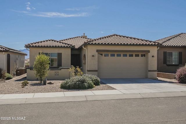 mediterranean / spanish house featuring concrete driveway, a tiled roof, and stucco siding