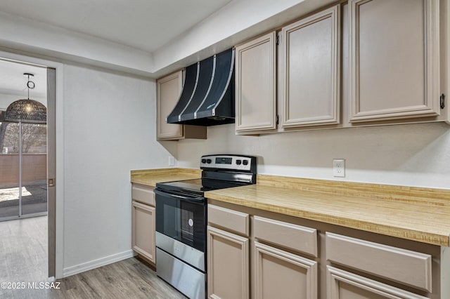 kitchen with light wood-style floors, wall chimney exhaust hood, wood counters, stainless steel electric range, and baseboards