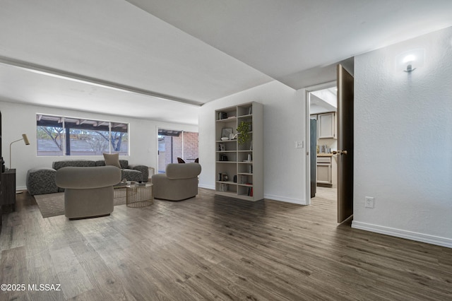 living room with dark wood-type flooring and baseboards