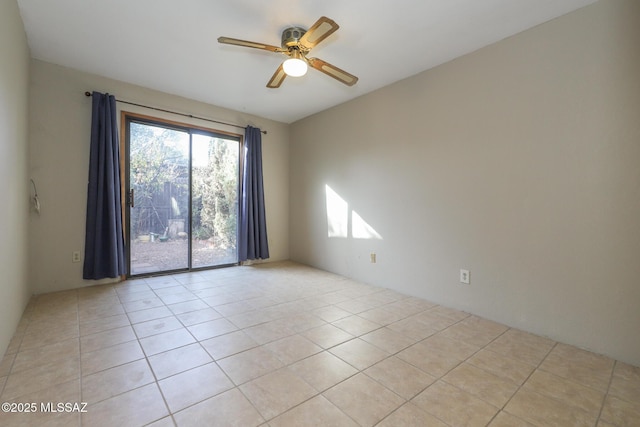 empty room with ceiling fan and light tile patterned flooring