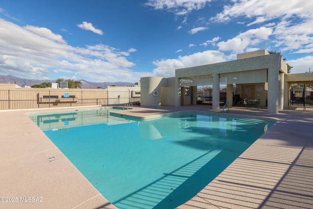 view of pool with a mountain view and a patio area