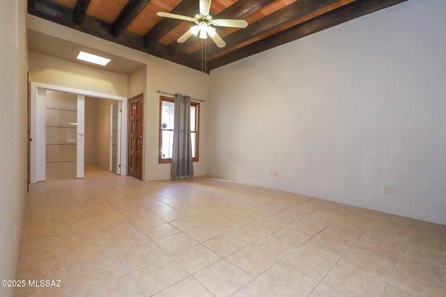 spare room with ceiling fan, light tile patterned floors, wooden ceiling, and beamed ceiling