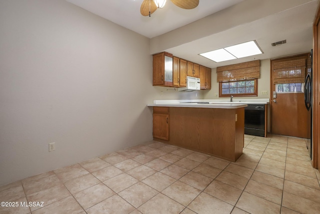 kitchen with black dishwasher, sink, light tile patterned floors, ceiling fan, and kitchen peninsula