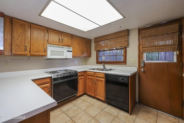 kitchen with range with electric cooktop, light tile patterned flooring, a skylight, black dishwasher, and sink