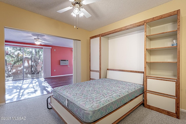 carpeted bedroom with ceiling fan, access to outside, and a textured ceiling