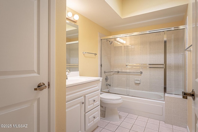 full bathroom featuring vanity, tile patterned flooring, bath / shower combo with glass door, and toilet