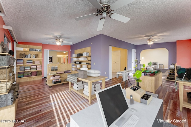 home office featuring dark hardwood / wood-style floors and a textured ceiling