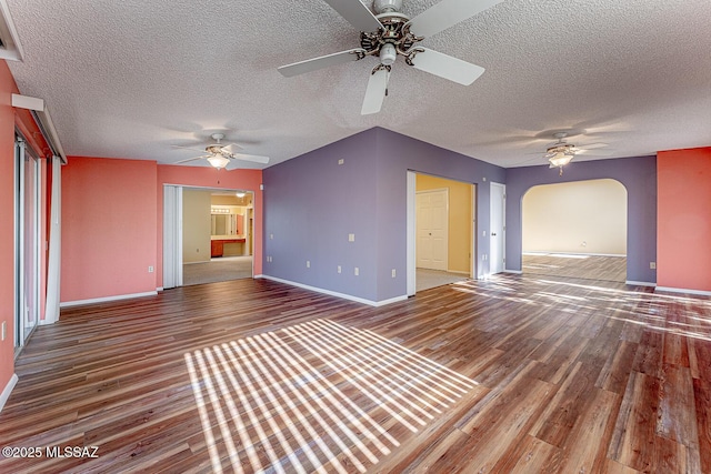 unfurnished living room with hardwood / wood-style floors and a textured ceiling