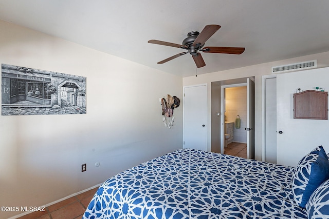 bedroom featuring connected bathroom, tile patterned floors, and ceiling fan