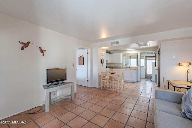 tiled living room featuring sink