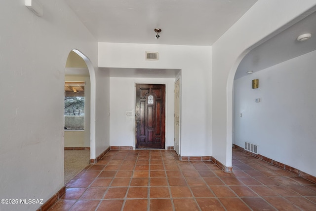 entrance foyer with dark tile patterned flooring