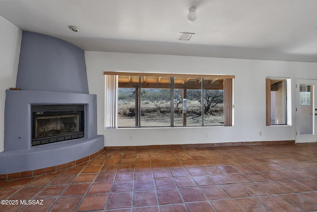 unfurnished living room featuring tile patterned floors and a large fireplace