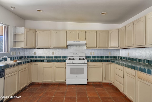 kitchen featuring tile countertops, sink, decorative backsplash, white range with gas cooktop, and stainless steel dishwasher