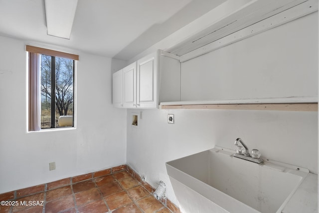 washroom with cabinets, hookup for an electric dryer, hookup for a washing machine, and sink