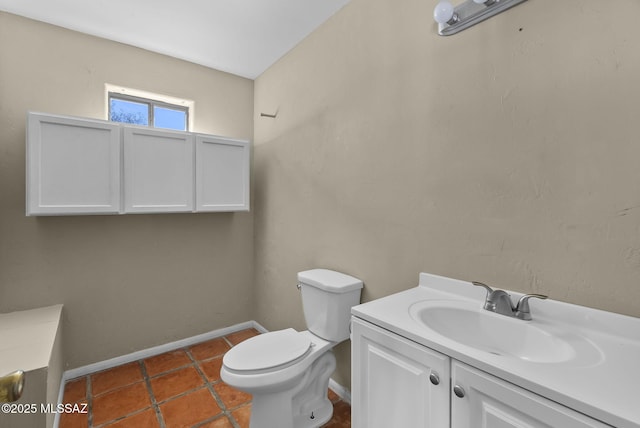 bathroom featuring vanity, tile patterned floors, and toilet