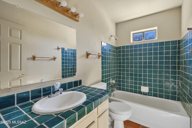 full bathroom with vanity, tiled shower / bath combo, and toilet