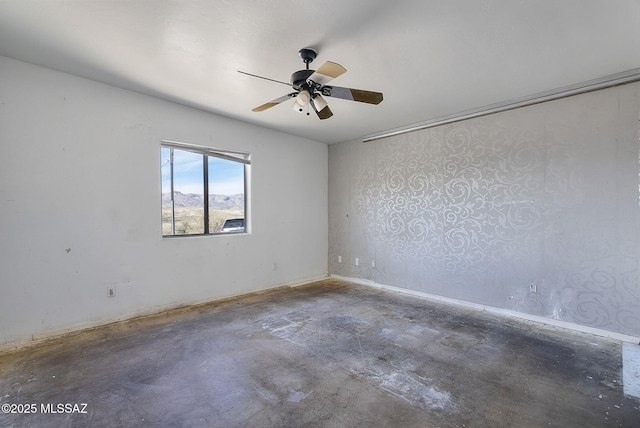 empty room with concrete floors and ceiling fan