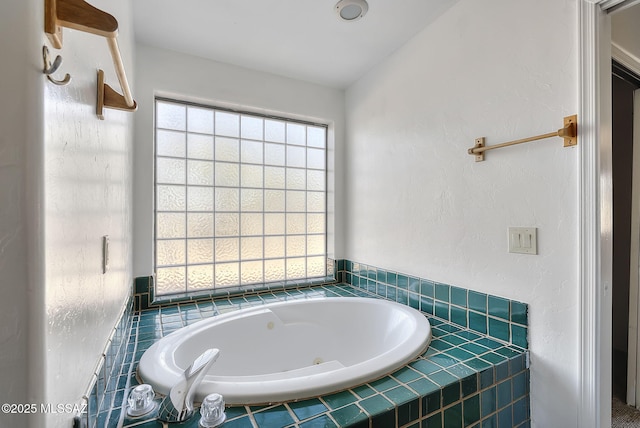 bathroom with tiled bath