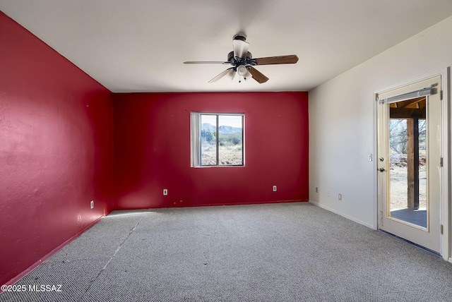 carpeted spare room with ceiling fan