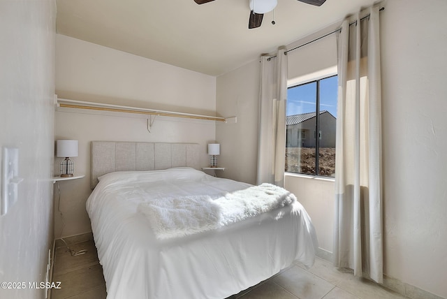 bedroom featuring light tile patterned floors and ceiling fan