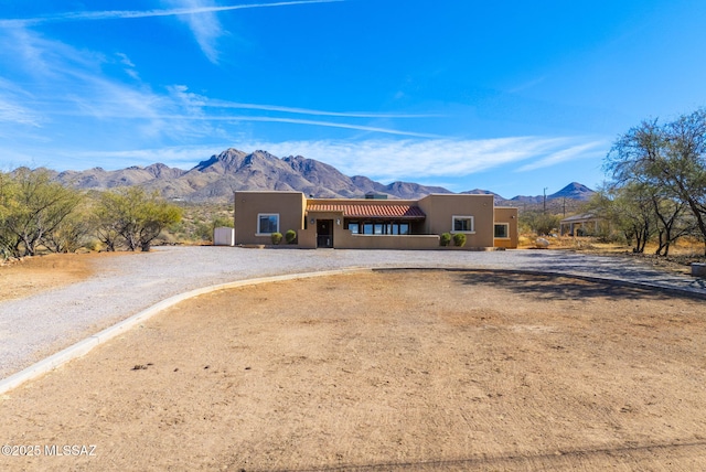 pueblo-style house with a carport and a mountain view