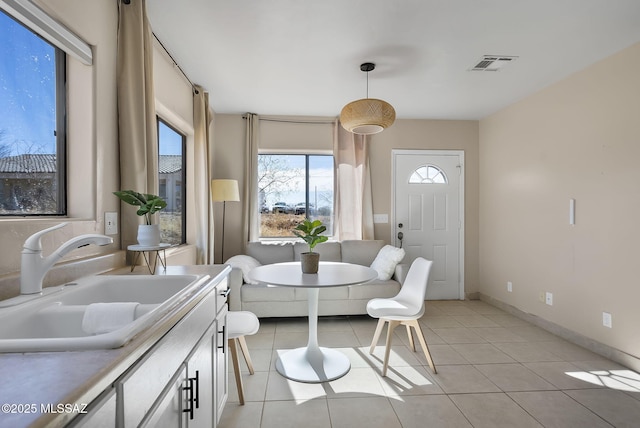 interior space featuring light tile patterned flooring and sink