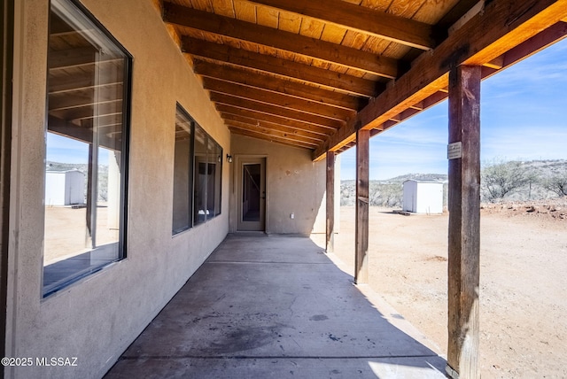 view of patio with a storage unit and a mountain view