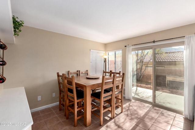 dining area featuring tile patterned flooring and baseboards