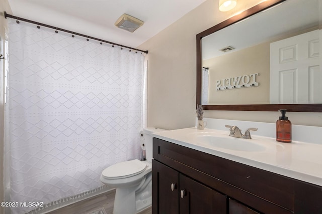 full bathroom featuring toilet, visible vents, wood finished floors, and vanity