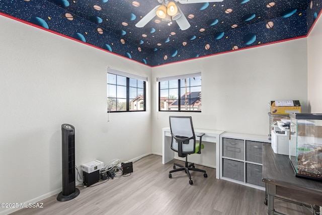 office featuring wood finished floors, a ceiling fan, and baseboards