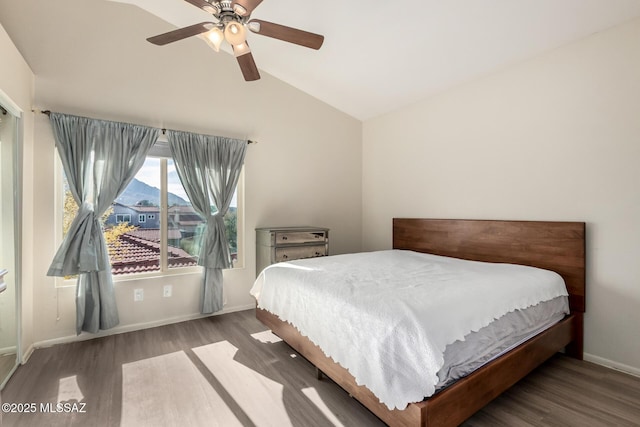 bedroom featuring lofted ceiling, ceiling fan, baseboards, and wood finished floors