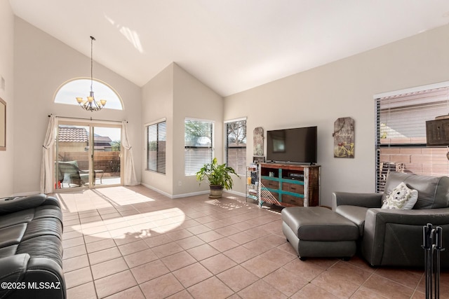 living area featuring light tile patterned floors, baseboards, a chandelier, and high vaulted ceiling